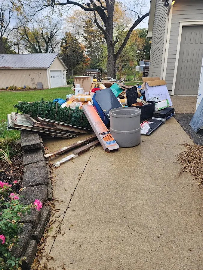 Dumpster being loaded with debris for Estate Cleanout Dumpster Rental in New Castle